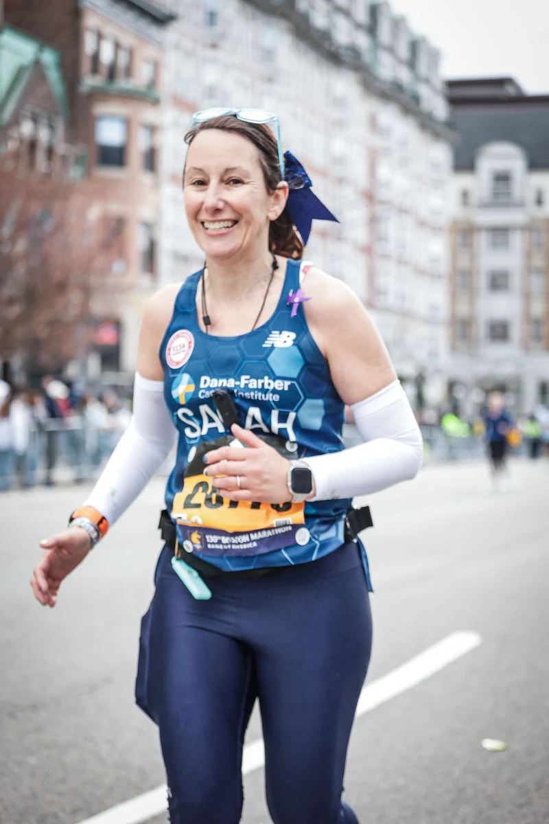 Sarah smiling while running the Boston Marathon
