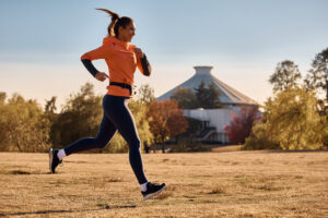 young happy athletic woman running in nature.