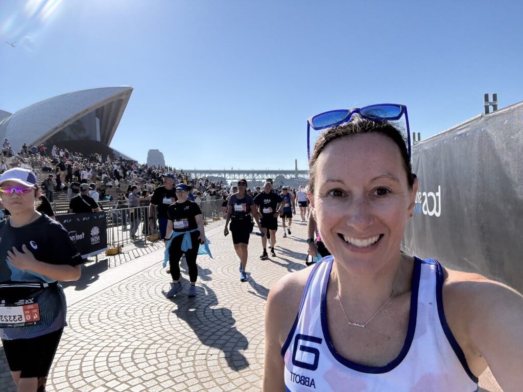 Running Sarah at finish line of Sydney Marathon in front of the Opera House